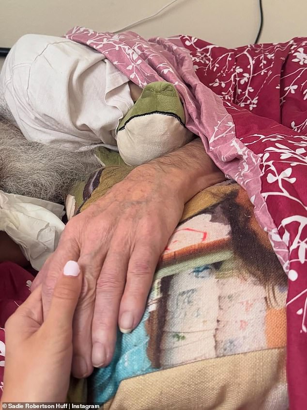 Sadie shared an emotional shot as she supported her ailing grandfather, holding his hand